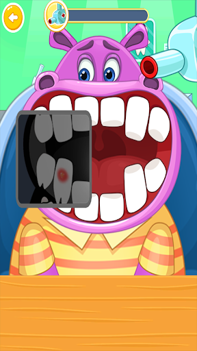 A joyful child plays a dentist game on a tablet, surrounded by colorful dental tools, symbolizing fun and education in dental care.