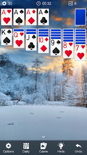 A person enthusiastically playing a game of solitaire, feeling a sense of nostalgia and excitement as they engage with a classic Klondike card game on their smartphone.